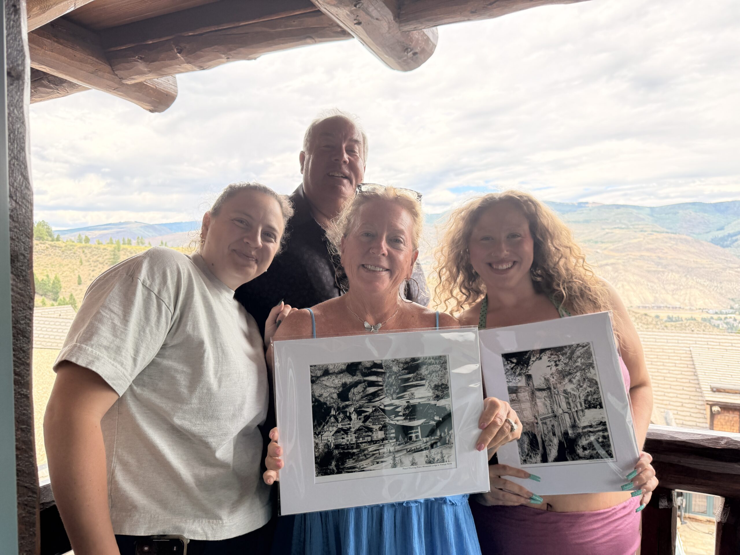 The Hull family holding their Along the Fence and Mountain Lodge in Vintage Hives prints